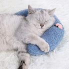A gray cat peacefully sleeping on a blue HappinessPaws calming pillow, designed for pet comfort