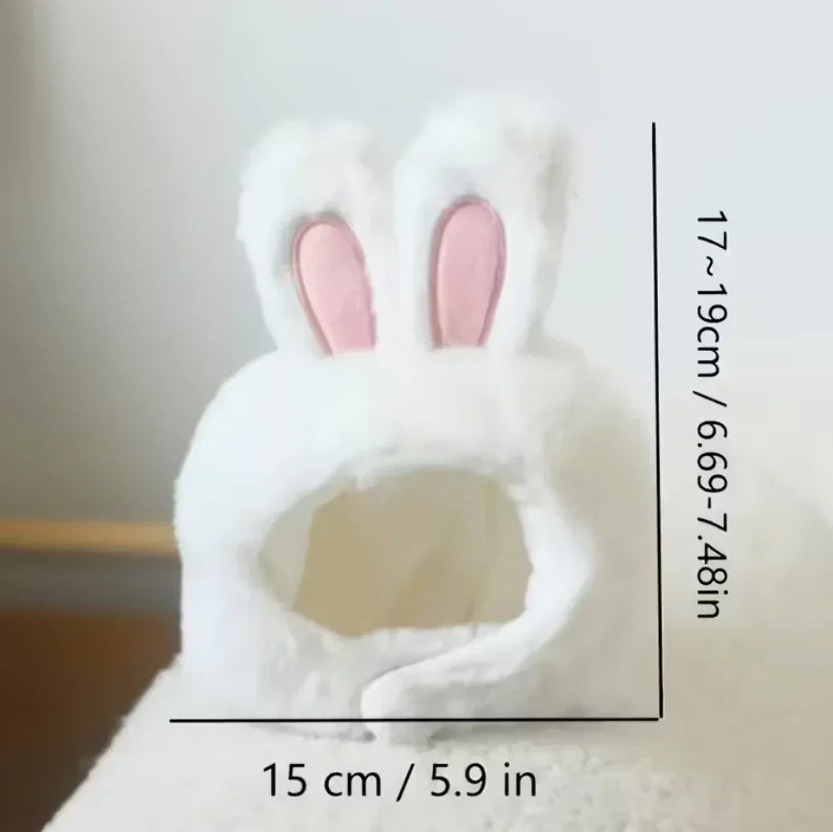 White plush toy with bunny ears and measurements on a neutral background
