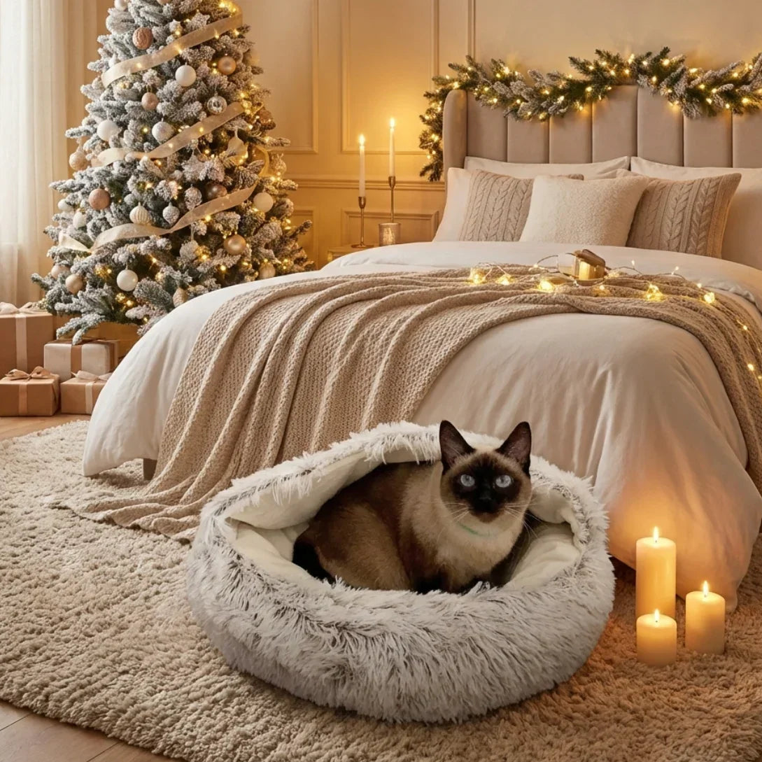 Cozy bedroom with a Siamese cat in a fluffy pet bed, Christmas tree, and decorations.