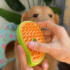 Close-up of the HappinessPaws dog grooming brush in green, highlighting soft orange bristles for effective grooming.