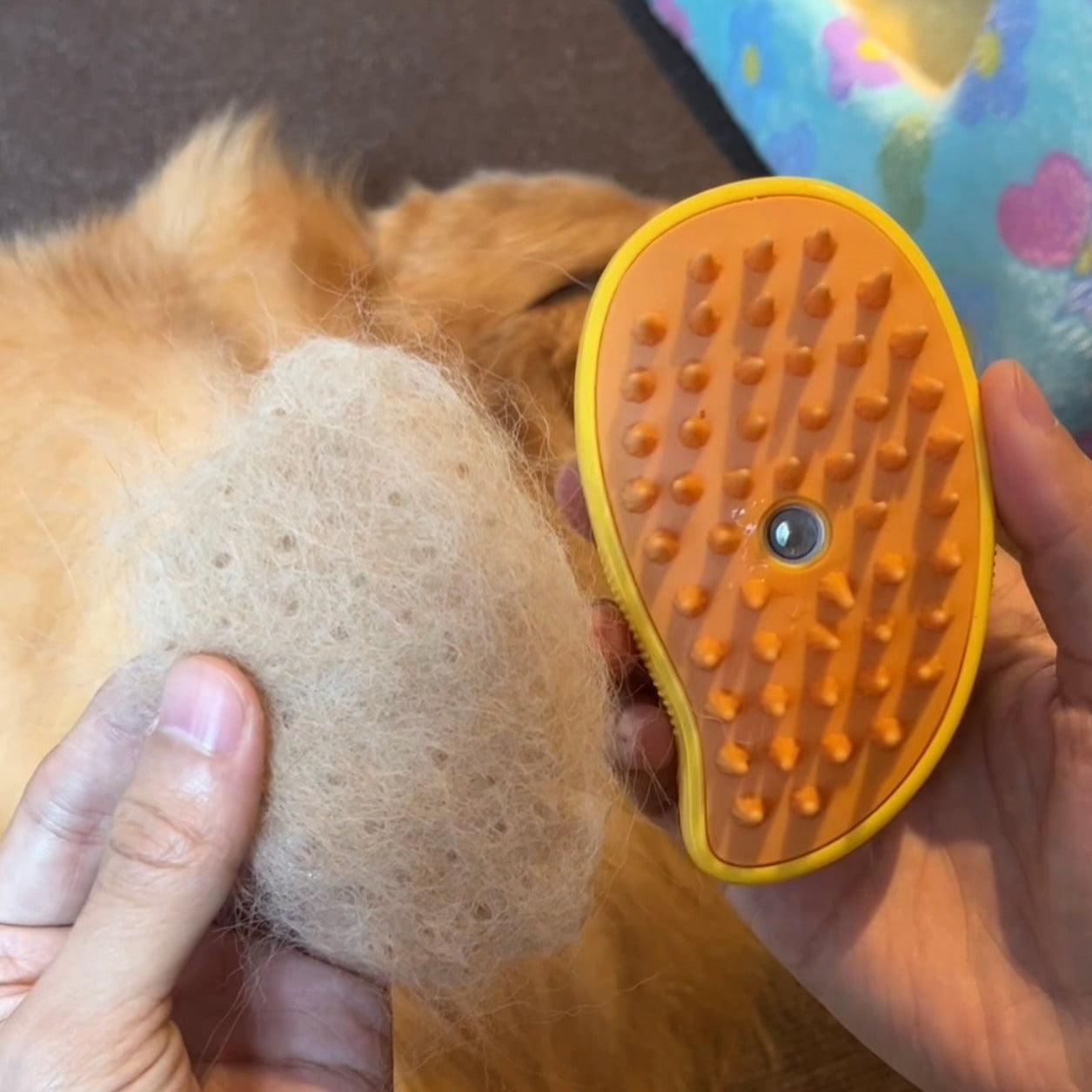 Close-up of the HappinessPaws grooming brush showing removed hair, demonstrating shedding efficiency.