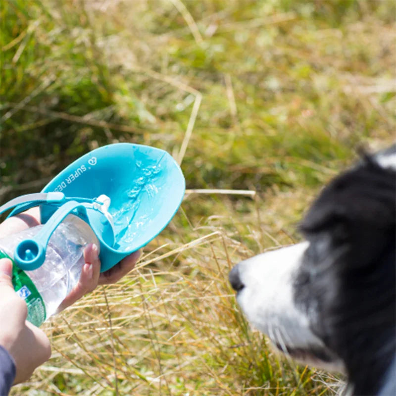 An image of the Travel Water Bottle for Dogs by HappinessPaws™, featuring a portable design for easy access to fresh water during travel.