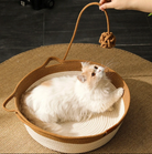 Cat sitting comfortably in the Chic Osier Cat Bed by HappinessPaws™ with a patterned cushion for added style.