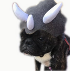 Dog wearing a gray helmet with white horns on a white background