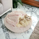 Cat relaxing inside a pink fluffy cozy cocoon bed on a marble floor, soft and comfortable sleeping space